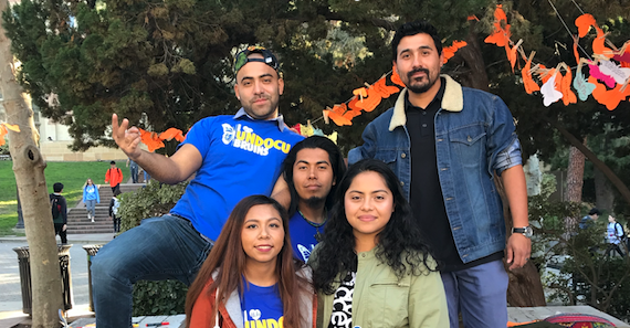 Five UCLA students posing at an event