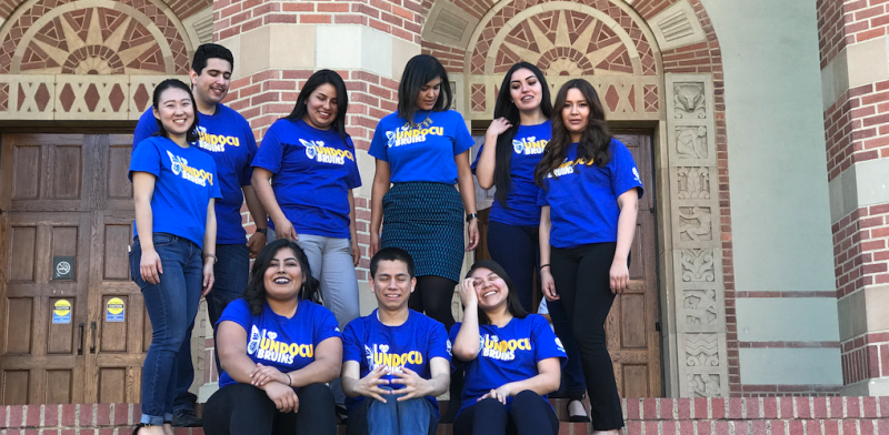 Students in the Undocumented Student Program posing in front of the Student Activities Center